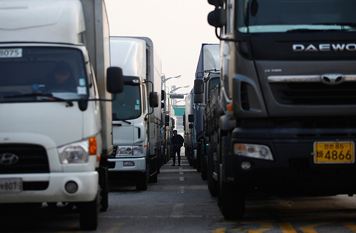 Korea tensions: A lorry driver walks between trucks waiting at the Kaesong  complex