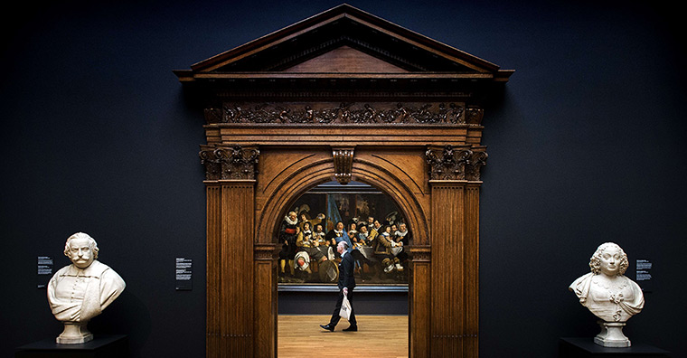 Rijksmuseum: A visitor walks by a painting during press-viewing day 