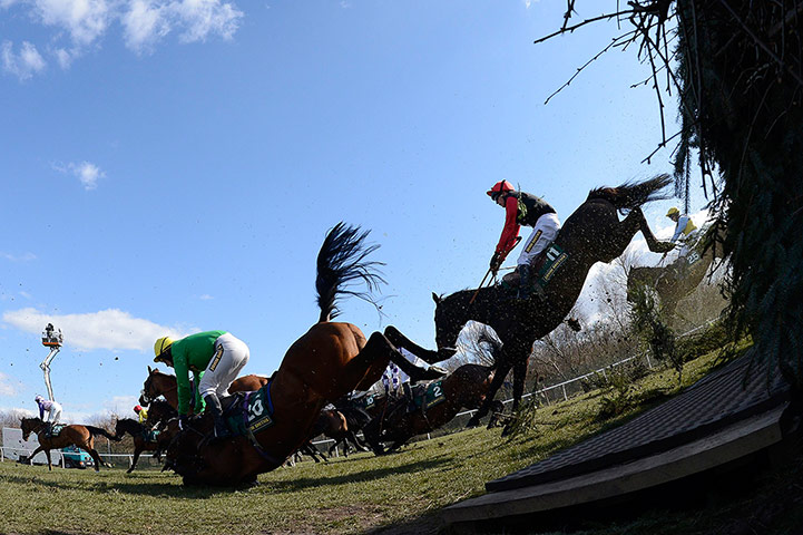 Dangers of Aintree: Competitors jump Beechers Brook