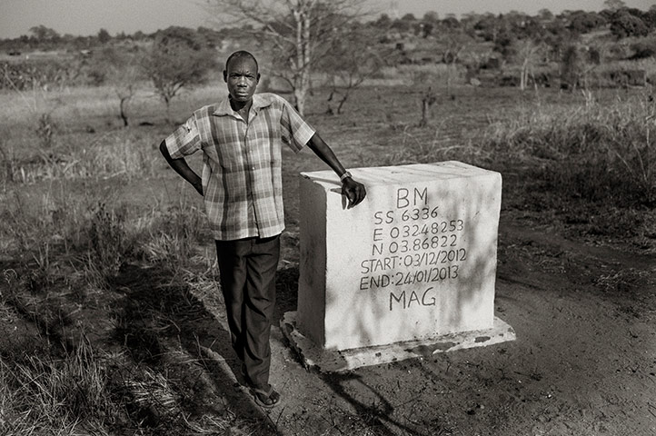 Boma chief poses by stone
