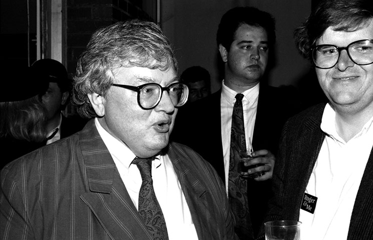 Roger Ebert: Roger Ebert and Michael Moore at the opening of Roger And Me