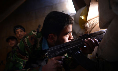 A Syrian rebel observes regime forces in Aleppo