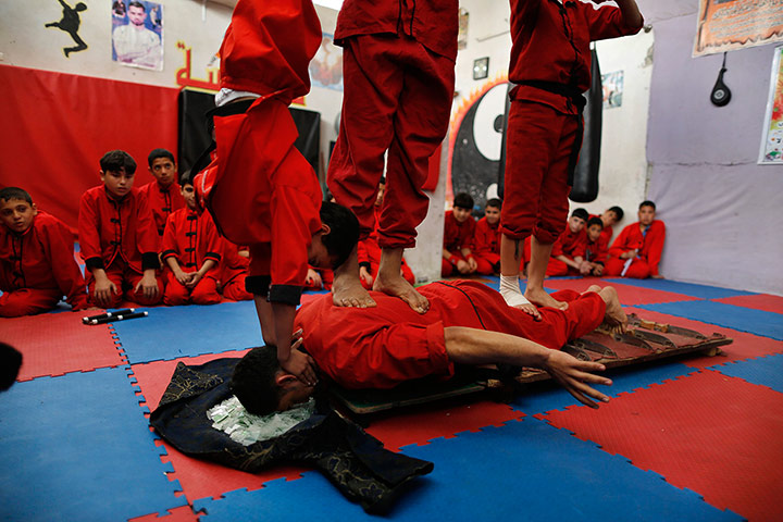 Best of the week: Palestinian boys stand at body of their classmate
