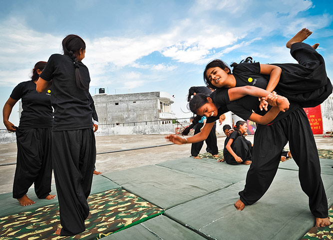 Women from the Red Brigade take part in a martial arts training session 