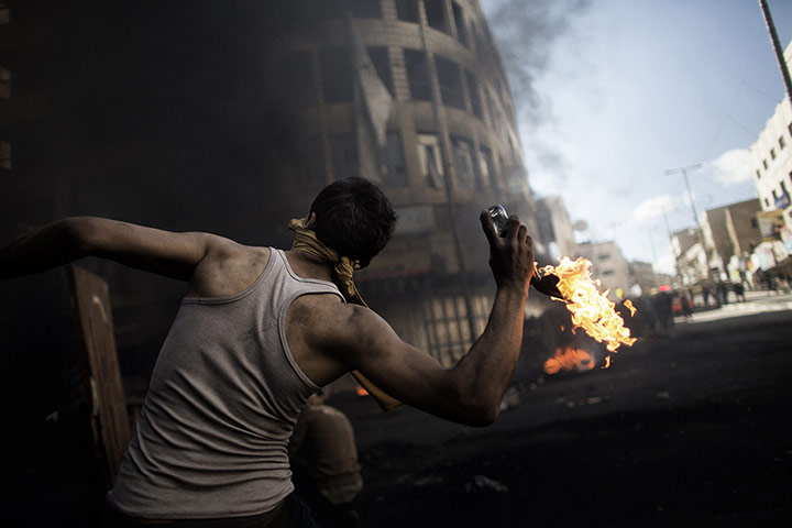 20 Photos: a Palestinian demonstrator throwing a petrol bomb in Hebron