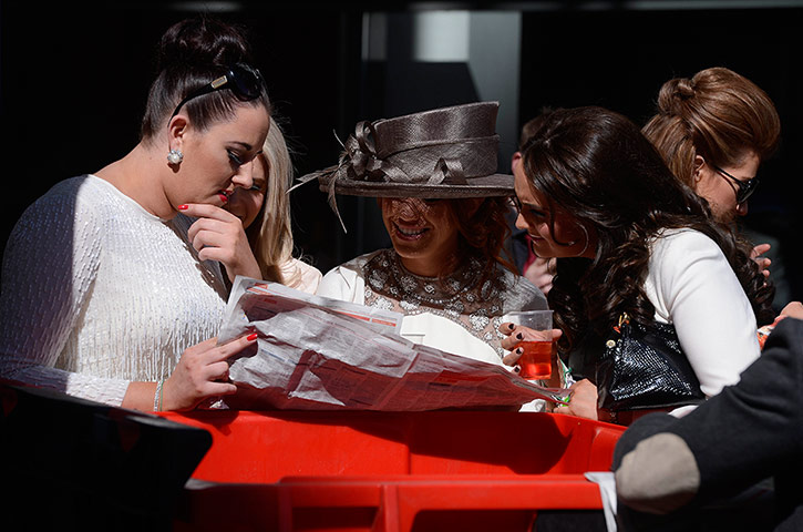 Grand National: A group of girls study the form at Aintree