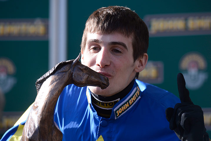 Tom Jenkins Aintree: Winning jockey Ryan Mania kisses the trophy 