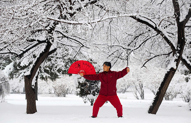 24 hours: Shenyang, China: A woman practices tai chi