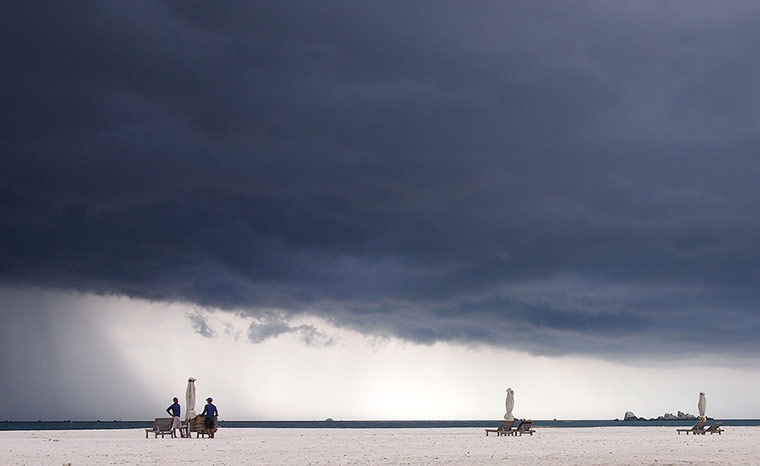 Your Pictures - April 13: empty beach scene with rain cloud overhead