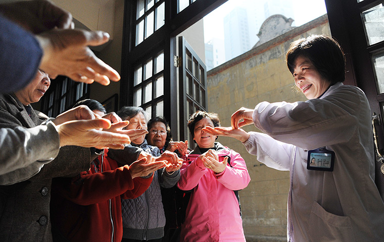 24 hours: Shanghai, China: A community medical worker shows how to wash hands