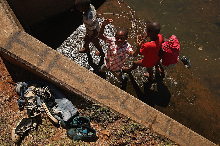 24 hours: Johannesburg, South Africa: Boys play in a large culvert in Thokoza Park