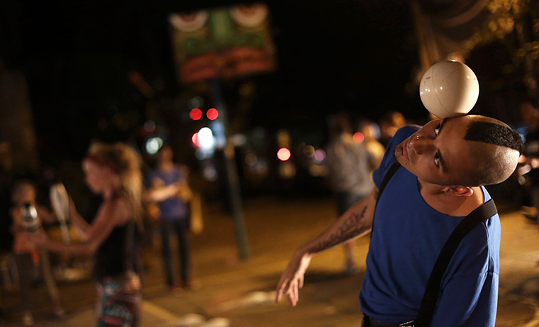 24 hours: Sao Paulo, Brazil: A juggler performs with a ball