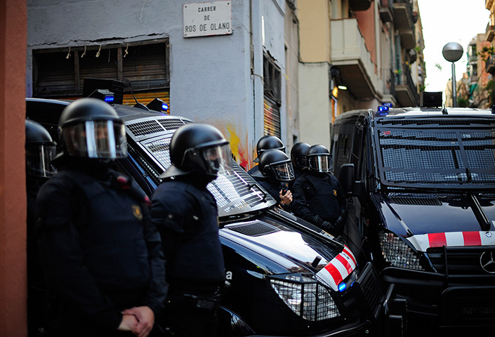 24 hours: Barcelona, Spain: Riot police stand in front of the Casal Popular of Graci
