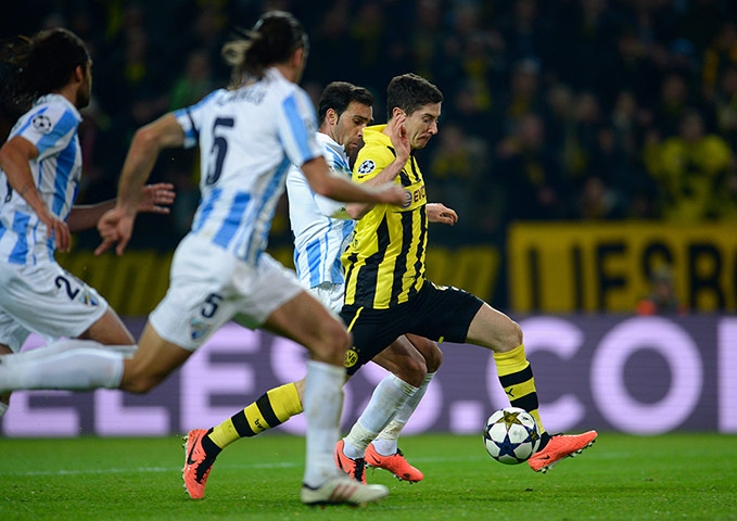 Dortmund against Malaga: Robert Lewandowski leads the Malaga defence on a merry dance
