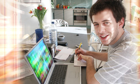 man writing with laptop