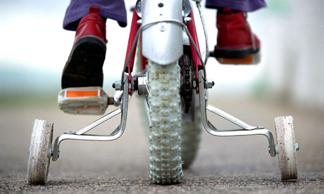 Young child on a bicycle with stabilisers