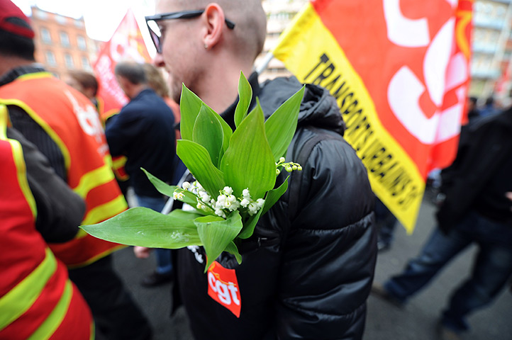May Day: A man holding a sprig of Lily of the Valley in Toulouse