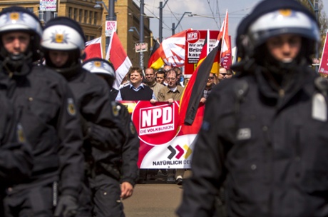 Supporters of the far-right NPD political party wave flags as they demonstrate in Schoeneweide district on May Day on May 1, 2013 in Berlin, Germany. Approximately 500 NPD supporters took part in the demonstration, and several thousand counter-protesters heckled them and attempted block the NPD demonstration route.