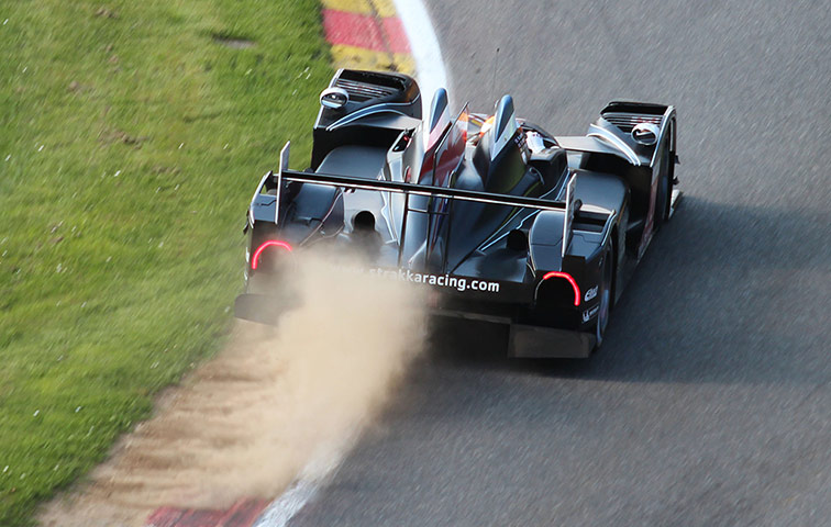 spa: Strakka Racing's Zytek catches the grass early in the race