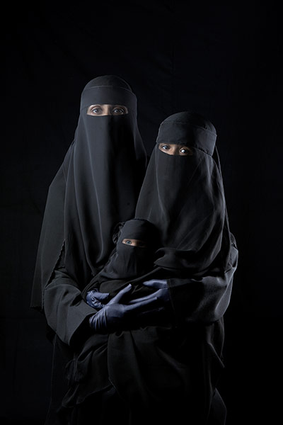 big picture - hijab: woman dressed in niqab with daughter and doll