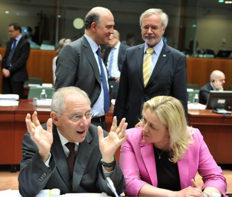 German Finance Minister Wolfgang Schaeuble and Finnish Finance Minister Jutta Urpilainen talk in front of (from L, background) French minister of Economy, Finances and Foreign Trade Pierre Moscovici and European Investment Bank President Werner Hoyer prior to an Economic and Financial Affairs meeting on May 14, 2013 at the EU Headquarters in Brussels.