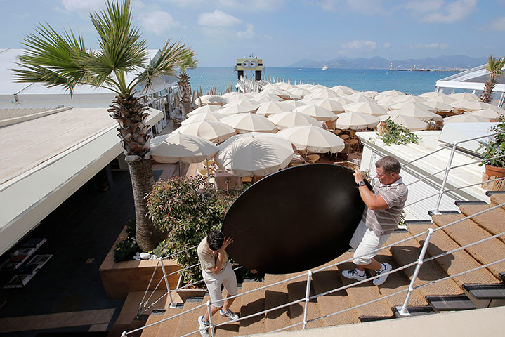 Cannes preperations: Workers make final preparations at a beach 