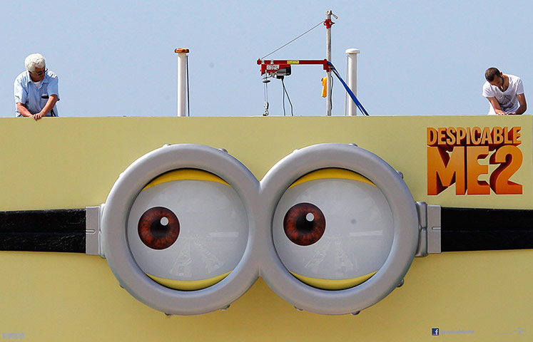 Cannes preperations: A Despicable Me 2 poster is installed on the Carlton Hotel pier