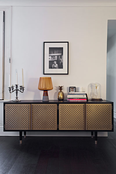Homes - Pettersen: vintage sideboard against a white wall 