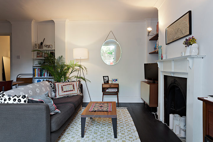 Homes - Pettersen: living room with fireplace and sofa and small table