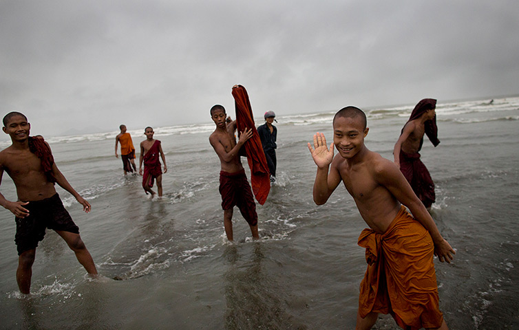 Cyclone Mahasen: Novice Buddhist monks play in the sea in Sittwe