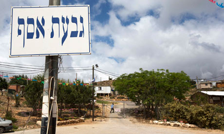 A signpost marks the entrance to the West Bank settler outpost of Givat Asaf, near Ramallah