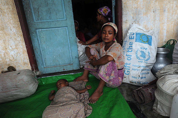 Cyclone Mahasen: A Rohingya family rests at a temperary r