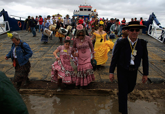Pilgrims: Pilgrims depart from a boat as they make their way to the shrine of El Roci
