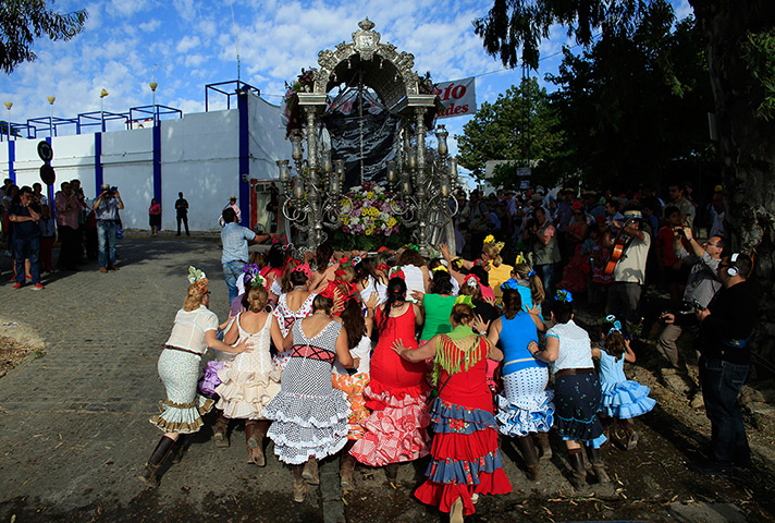 Pilgrims: Pilgrims from the Fuengirola fellowship push a cart, bearing a pennant of a