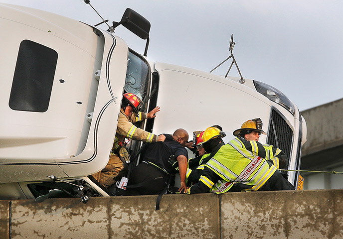 Tornado in USA: Firefighters assist a lorry driver as he is taken from his overturned truck