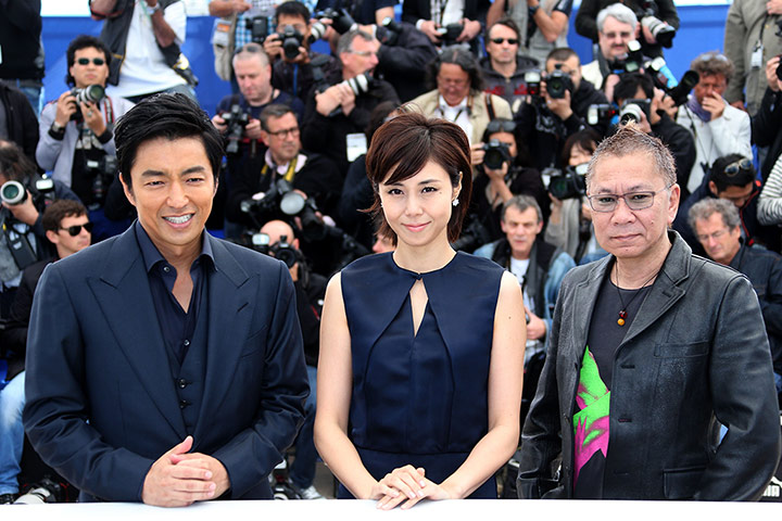 Cannes photocalls: Actors Takao Osawa and Nanako Matsushima with director Takashi Miike pose f