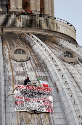 Italian businessman Marcello De Finizio stands on the dome of St Peter's basilica to protest against austerity measures on May 21, 2013 at the Vatican. The businessman hung a banner saying: