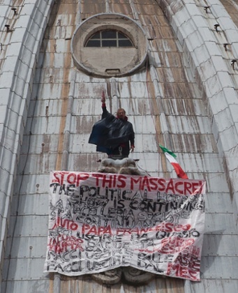 Italian businessman Marcello di Finizio stands by his banner with writings against the Italian Government and the Euro as he protests on St. Peter's 130-meter-high (42-feet-high) dome, at the Vatican, Tuesday, May 21, 2013.