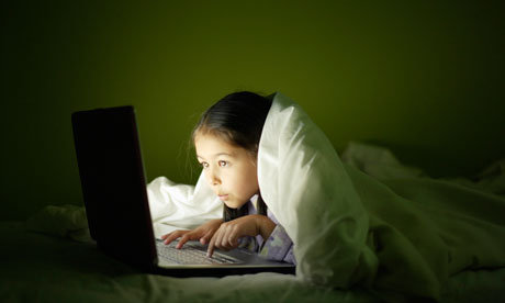 Girl using laptop at night