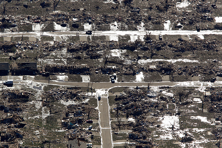 Moore aerials: People walk through a destroyed neighbourhood