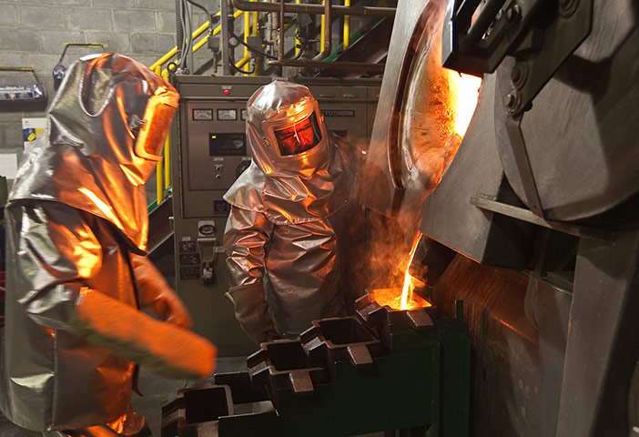 WGC gallery: WGC: Workers pour molten gold from crucible