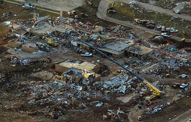 Moore aerials: Rescue workers continue their efforts searching through rubble of Plaza Tow