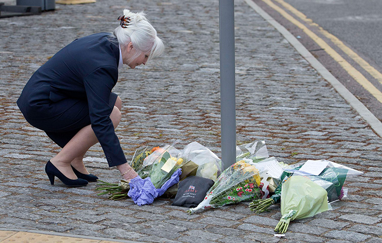 Woolwich aftermath: A woman places flowers outside the Royal Military Barracks