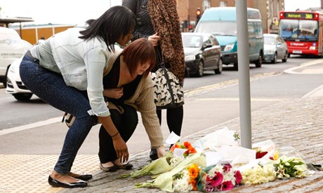 Women lay flowers near the scene of the killing of a British soldier in Woolwich, southeast London