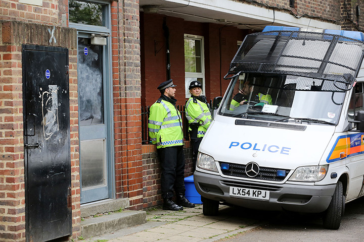Woolwich response: Police officers outside a flat off Eastney Street in Greenwich