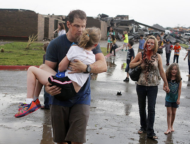 20 Photos: Steve Cobb carries his daughter Jordan after the tornado in Oklahoma
