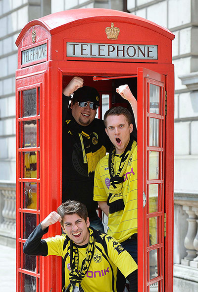 Germans in London: Borussia Dortmund supporters in a traditional red telephone box