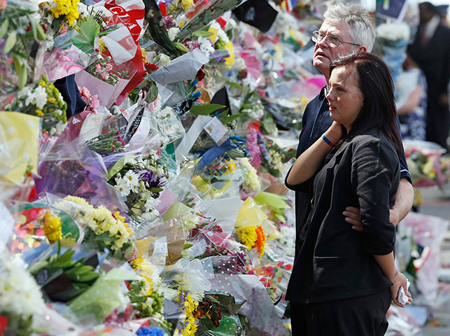 Woolwich tributes: Ian Rigby, the stepfather of Lee Rigby, and Sarah McClure look at floral tr