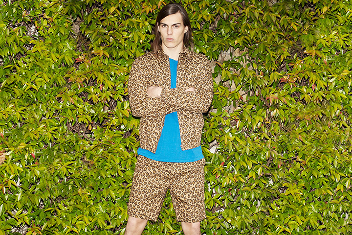 Fashion - Men's Print: Male model in print shorts and shirt against leaves