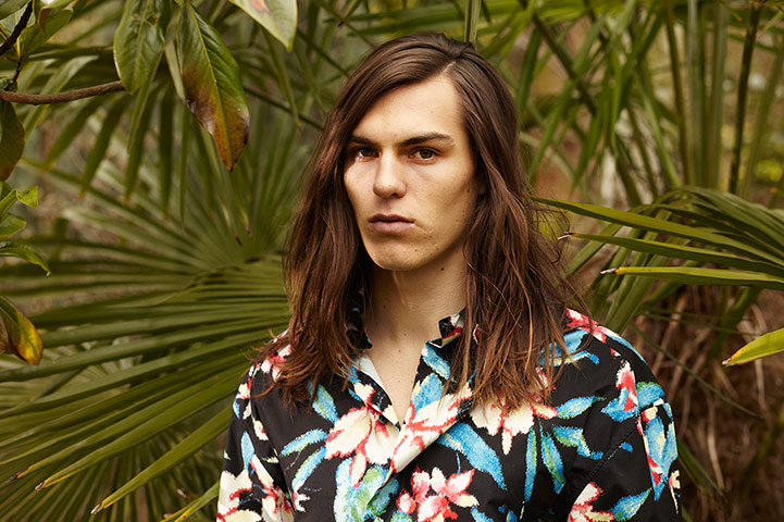 Fashion - Men's Print: Male model wearing print floral shirt against foliage